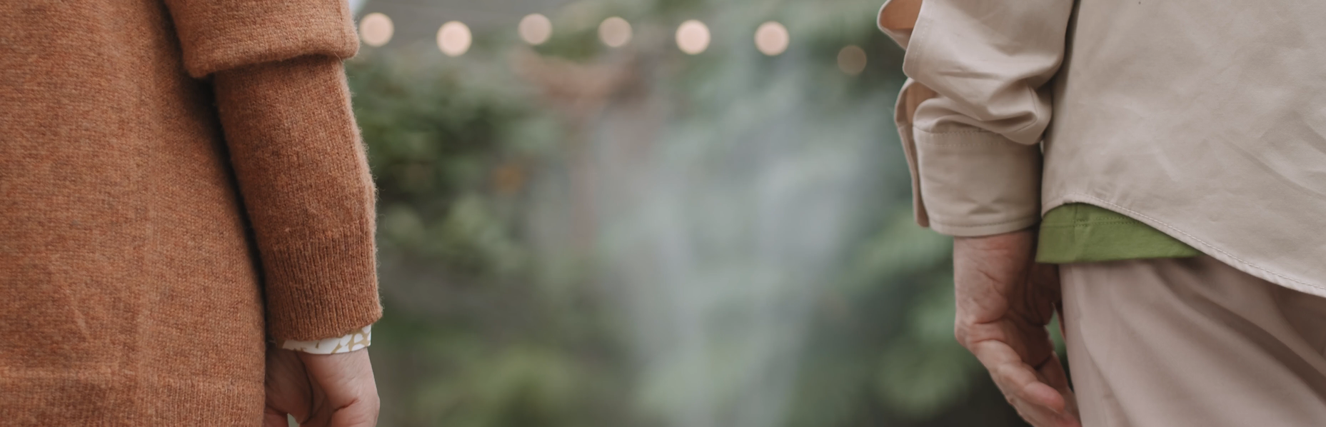 behind view of 2 seniors hands