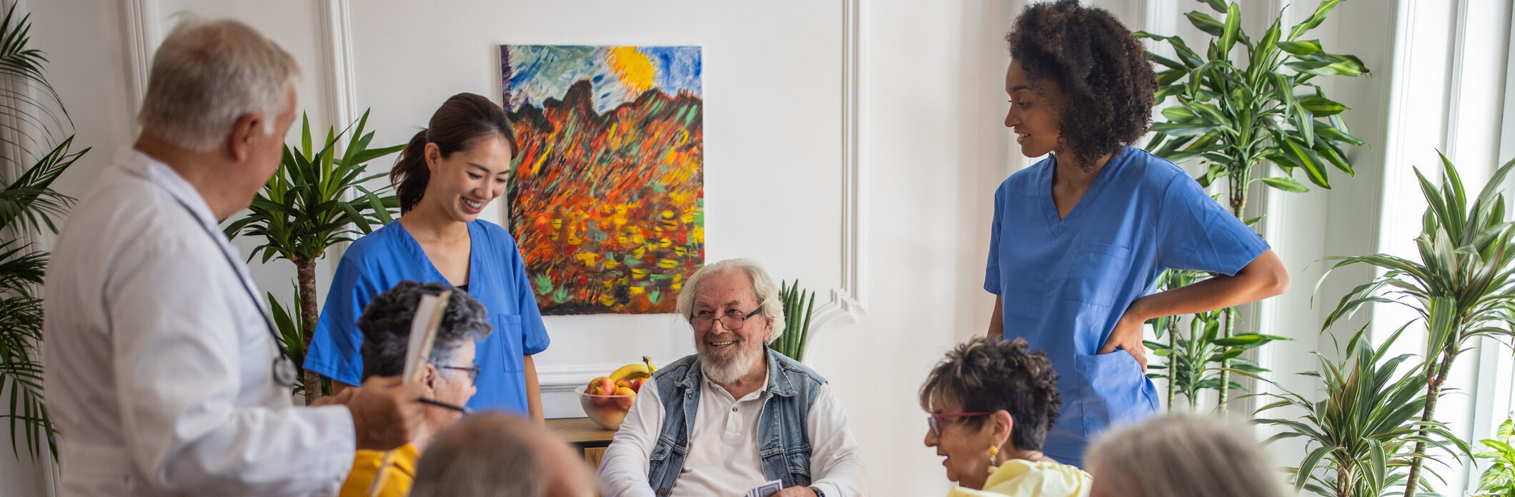 Happy senior people playing card at nursing home