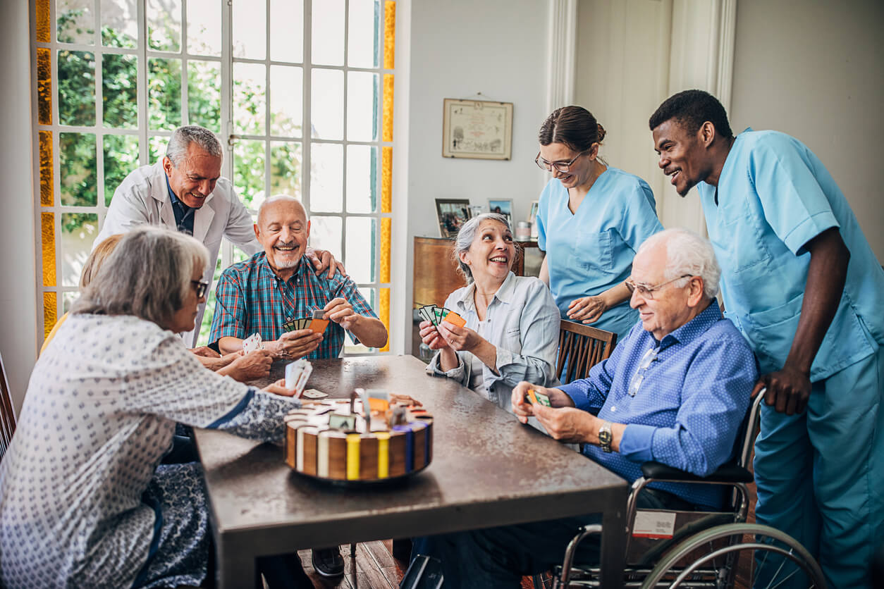 Group of people, senor people playing cards in nursing home.