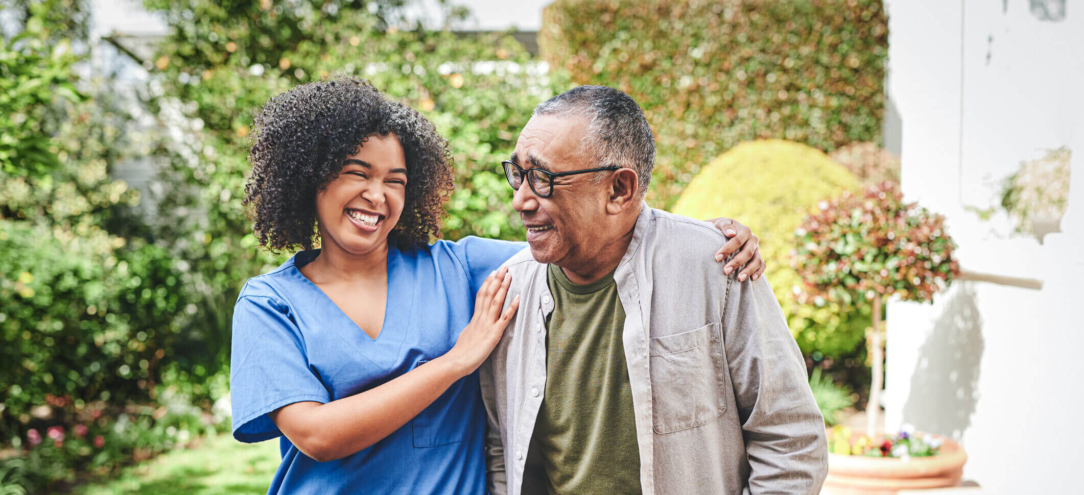 Shot of a young nurse bonding with her senior patient outside