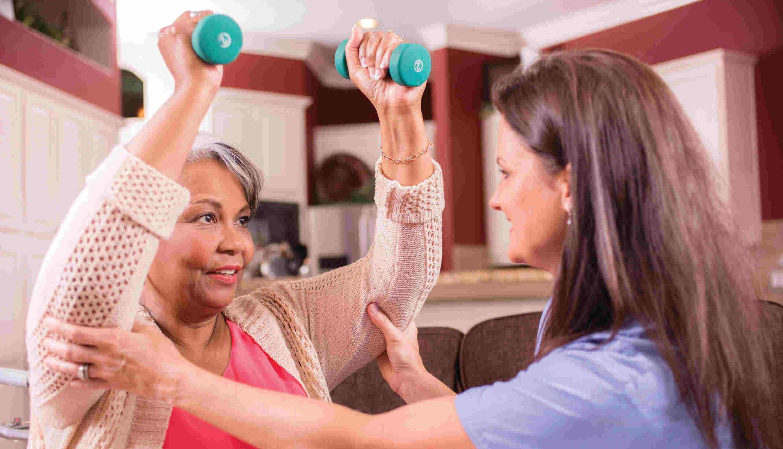 healthcare nurse conducts physical therapy exercises with senior patient